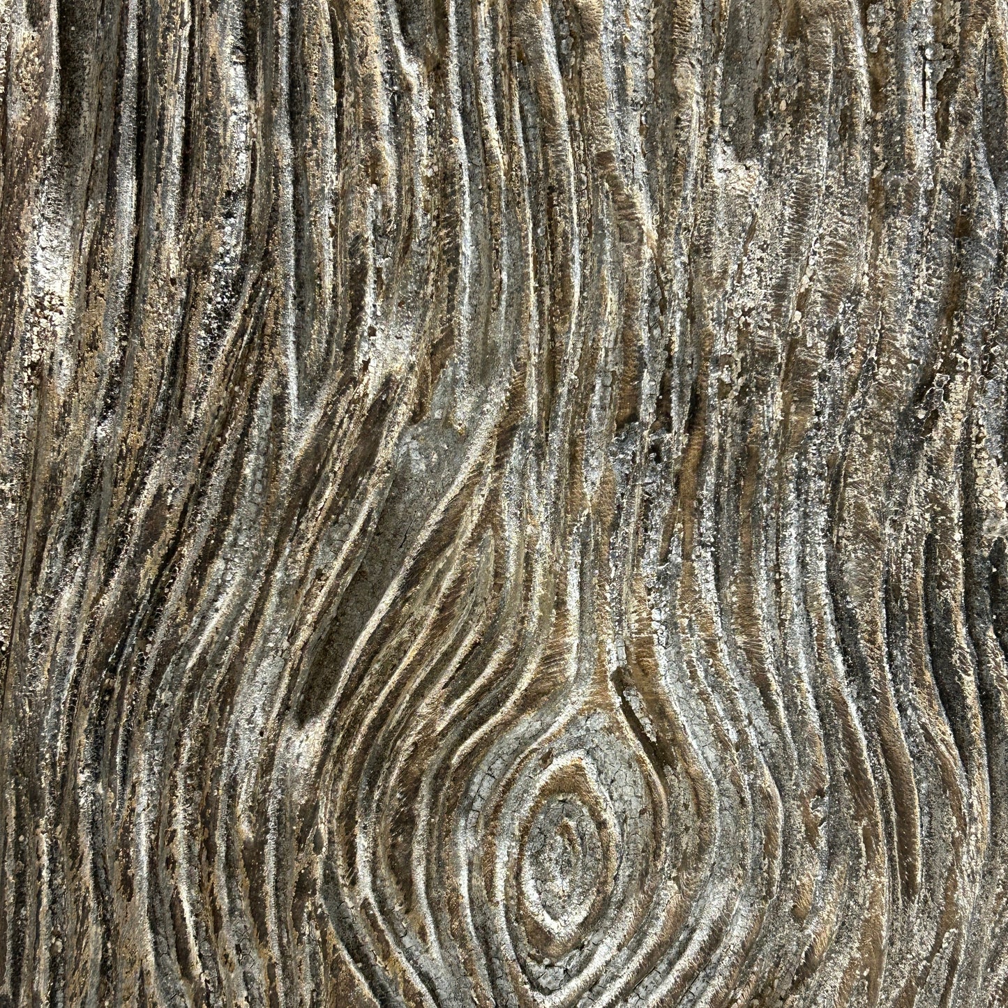 Close-up of carved timber surface with concentric circular patterns