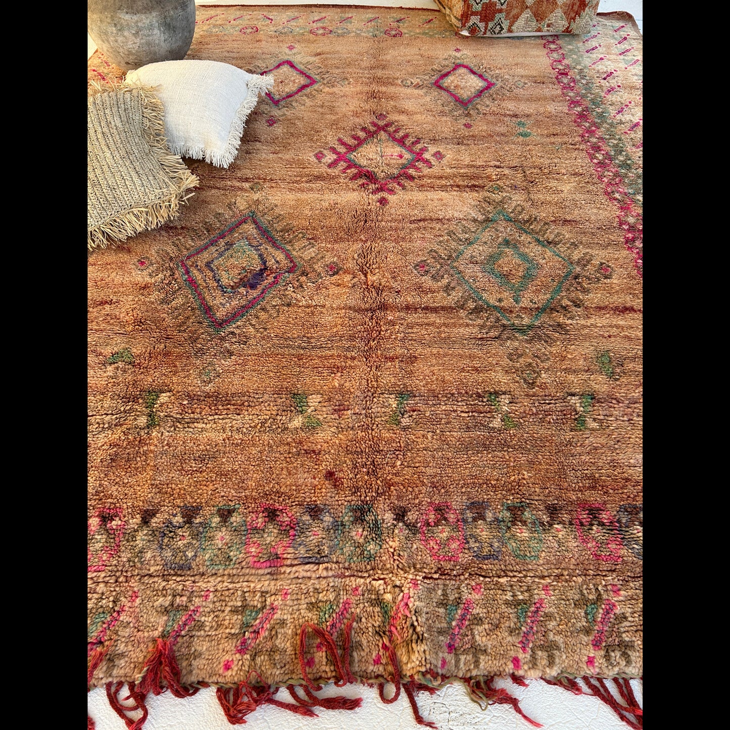 Boujaad Moroccan rug with geometric patterns and fringes on a white background