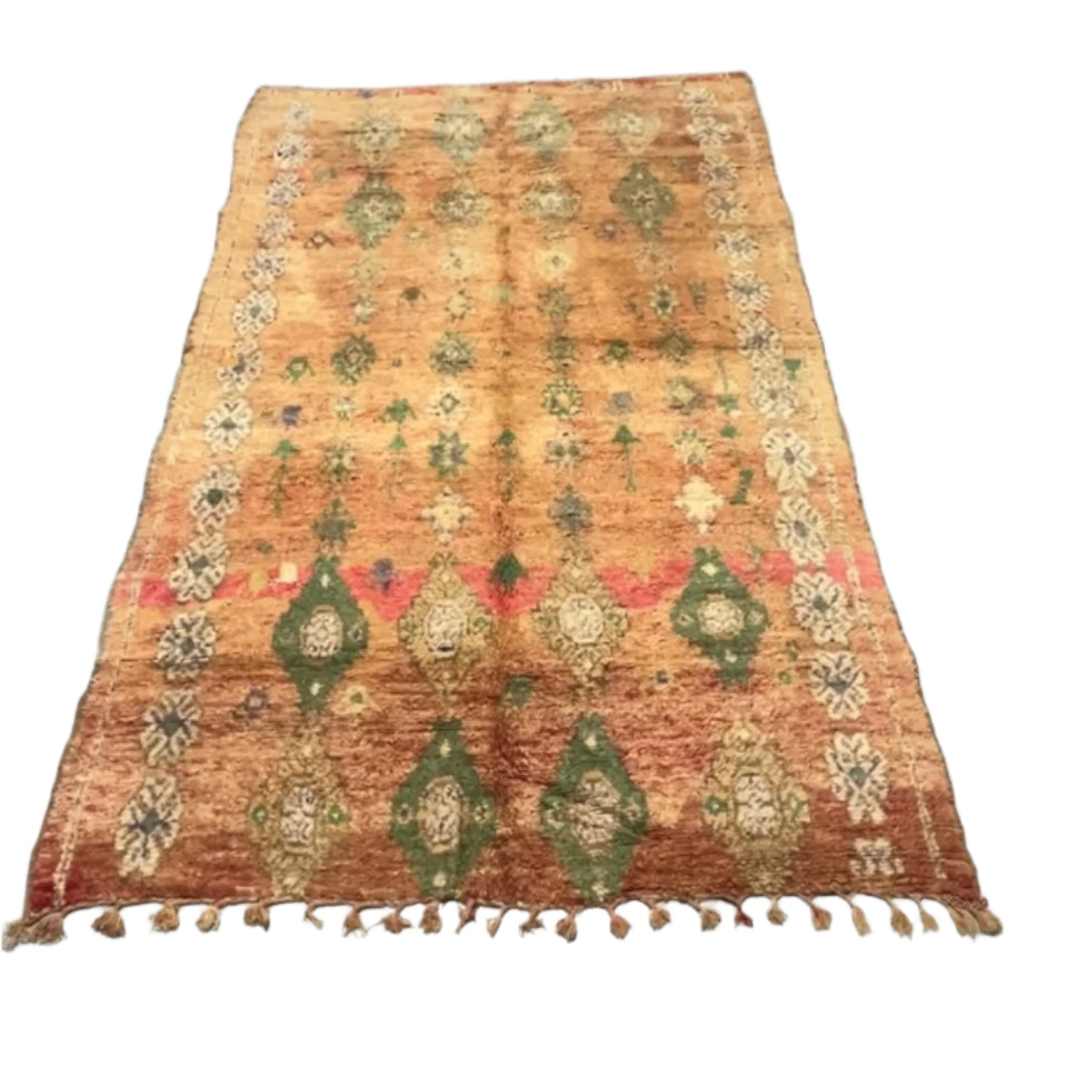 Moroccan Boujaad rug with a pinky-apricot base, featuring a white clover-style border and multi-colored woven teapot motifs.