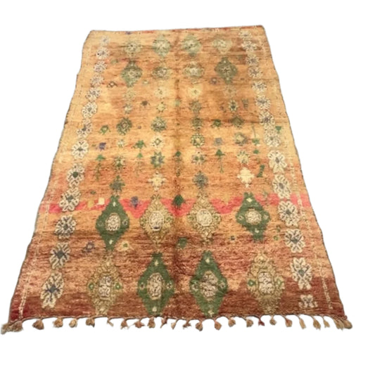 Moroccan Boujaad rug with a pinky-apricot base, featuring a white clover-style border and multi-colored woven teapot motifs.