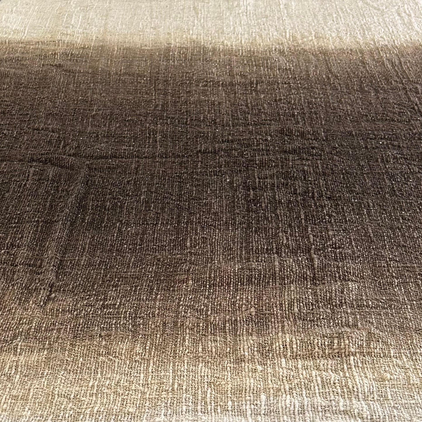 Textured fabric of the Espresso Throw shown laying flat with a graduation from neutral to espresso and back to neutral.