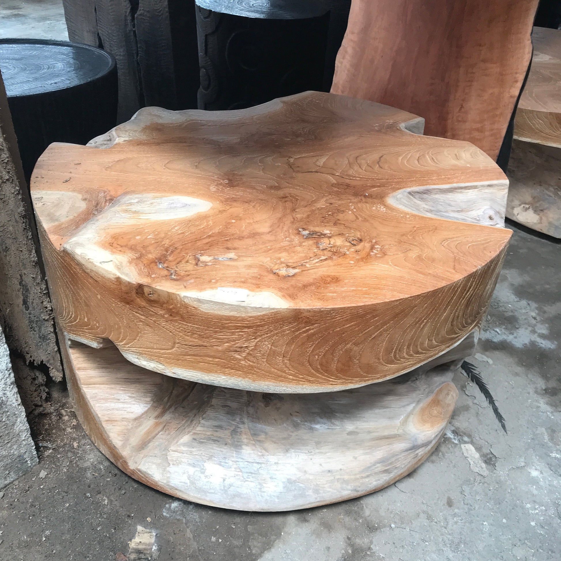 Wooden stool with a natural finish on a concrete floor