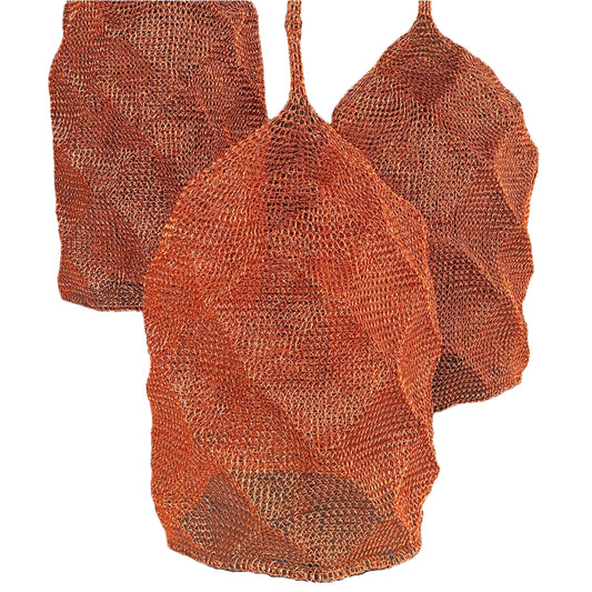 Three copper woven mesh pendant lights on a white background.