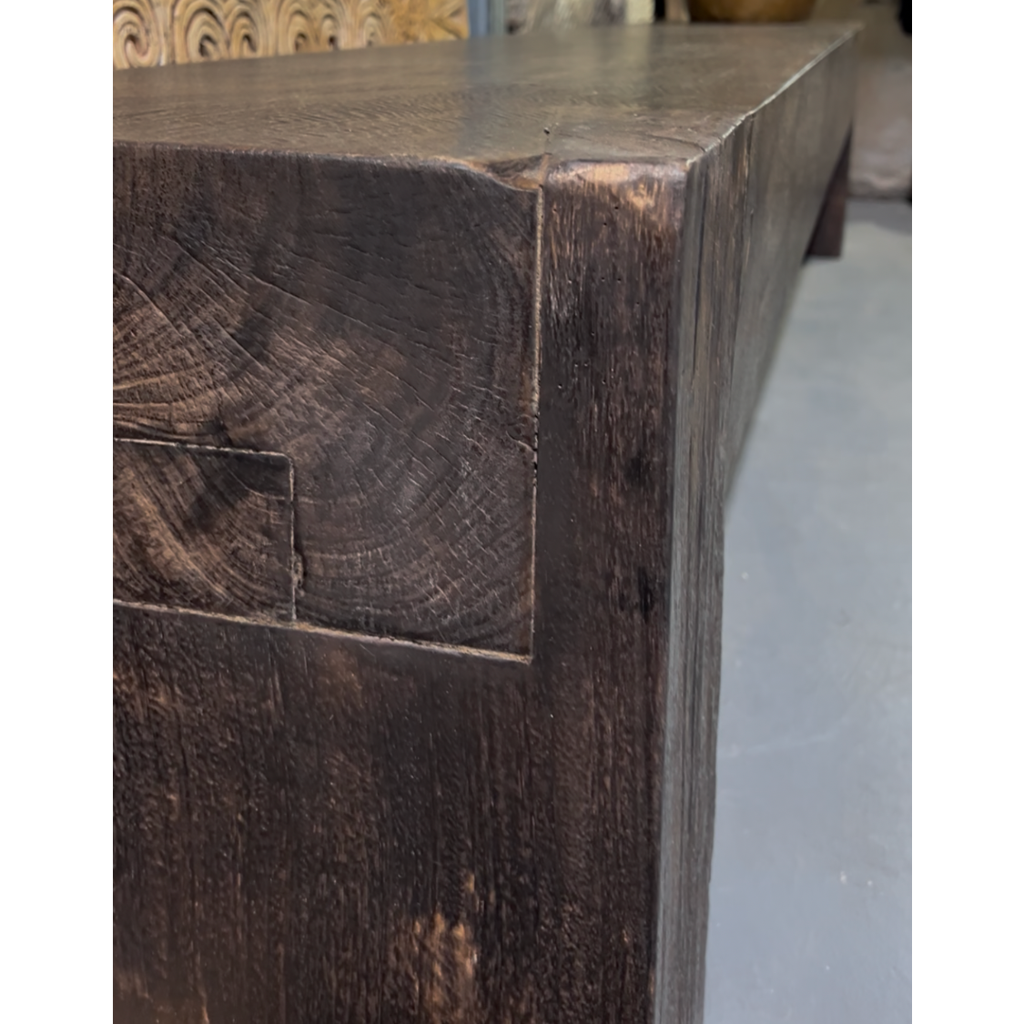 Dark wooden bench with rustic finish