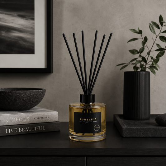 Aurelius diffuser on a dark surface with decor items in the background
