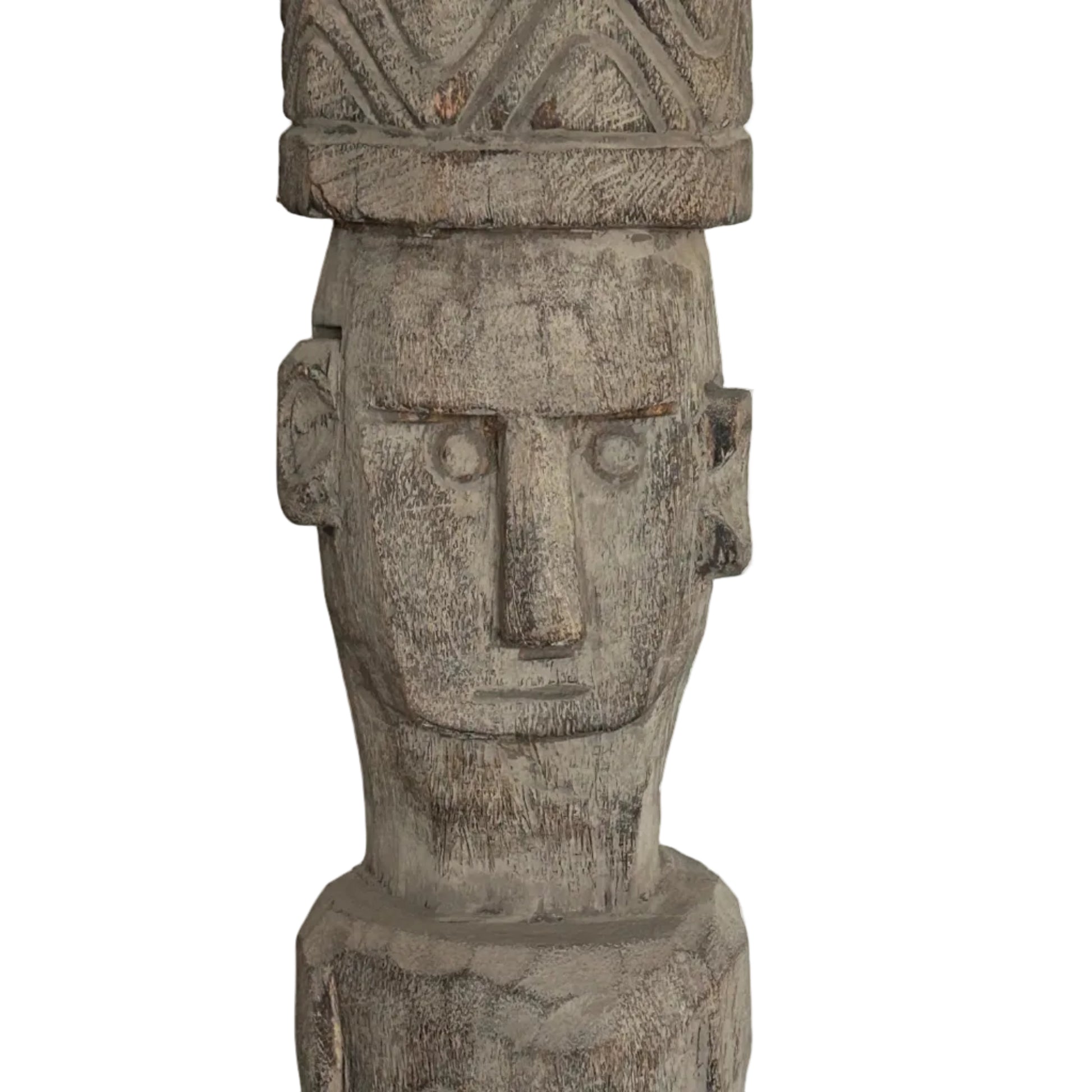 Close up frontal of face of a wooden Timor totem statue with intricate carvings on a plain background.