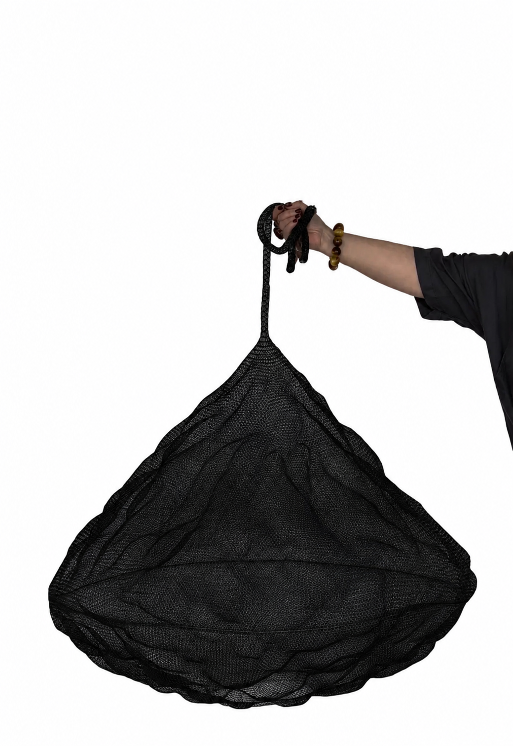 Nomad Pendant in Black mesh shown with a person holding it against a white background.