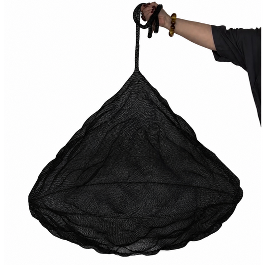 Nomad Pendant in Black mesh shown with a person holding it against a white background.