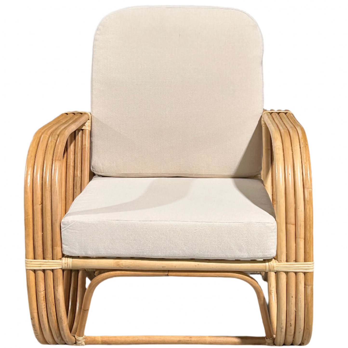A rattan Slingback Chair with a cushion, showcasing a brown rattan frame and a beige cushion.