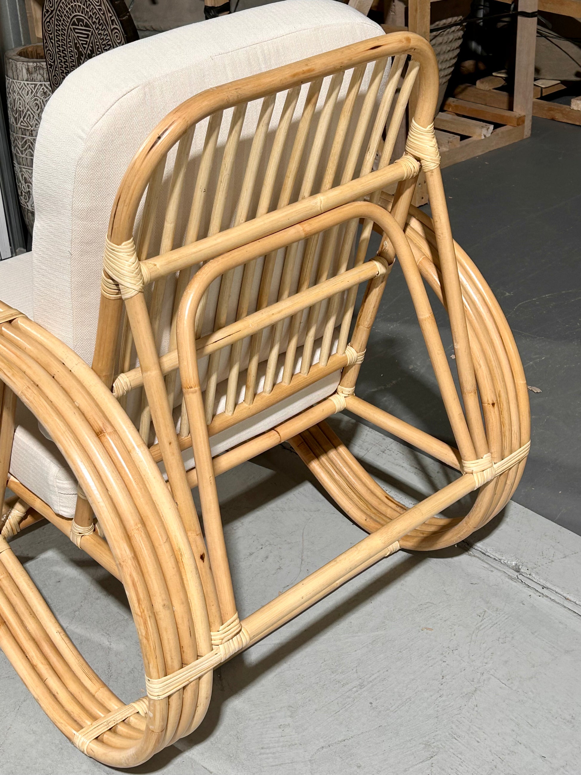 Back view of the Slingback Rattan Chair against a grey floor