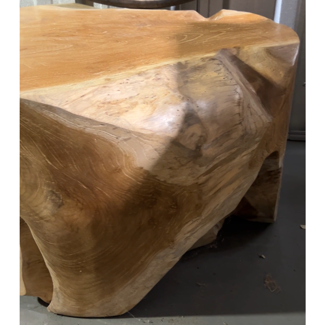 Wooden table with timber grain surface on a grey floor