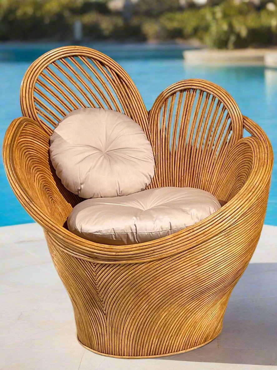 The Petali chair shown against the backdrop of a pool and gardens