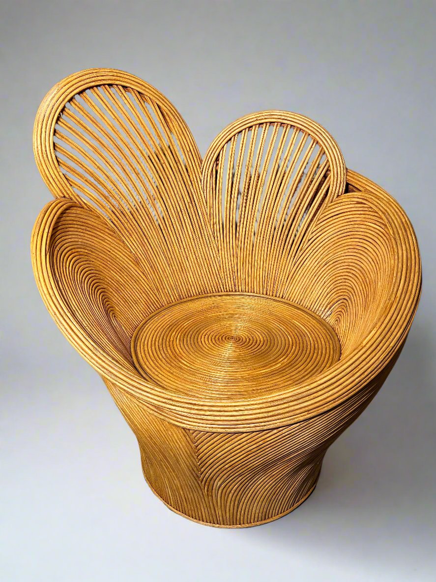 Woven rattan single chair in the shape of flower petals shown against a plain grey background