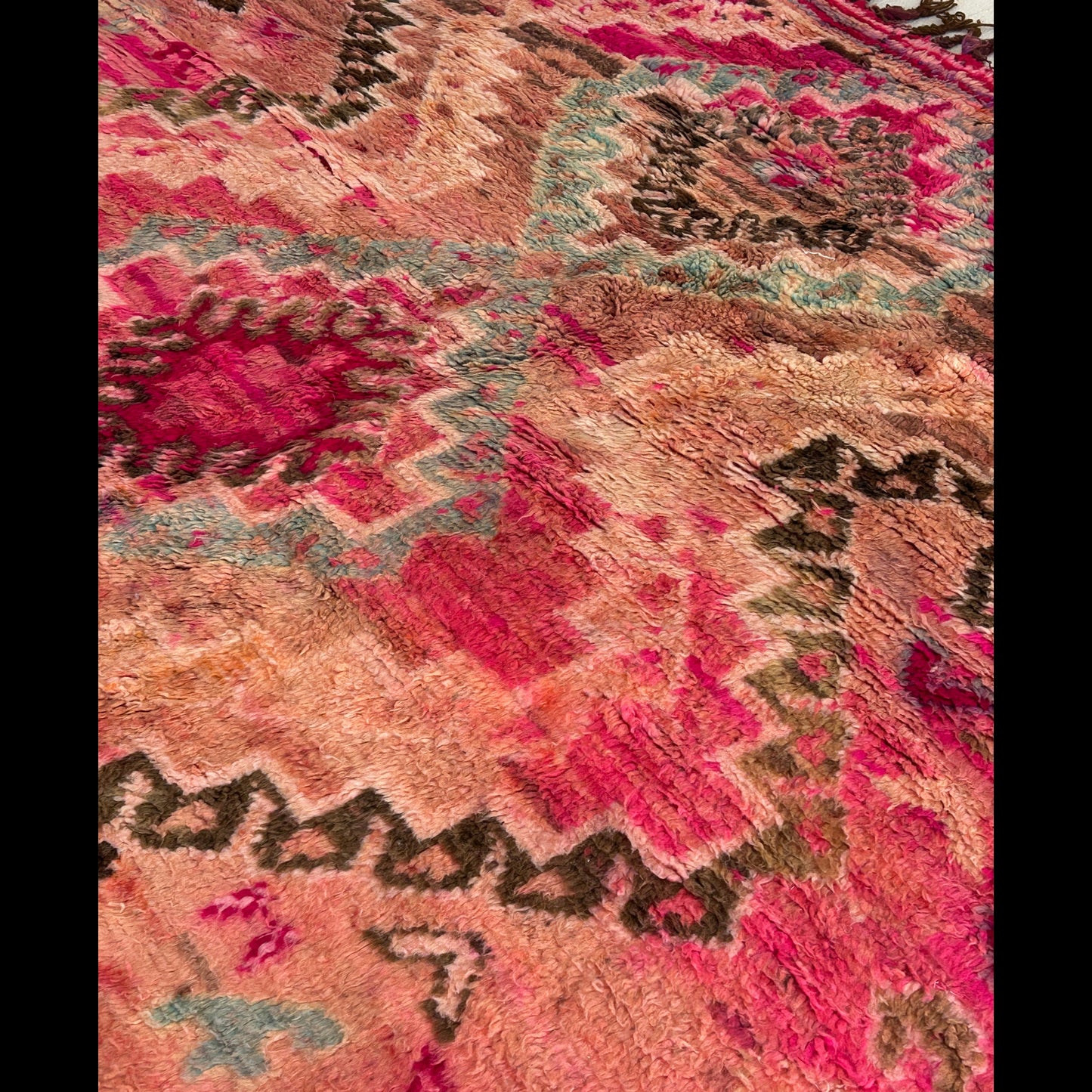Vintage Boujaad rug close-up showing magenta and pink s with brown and blue patterns 