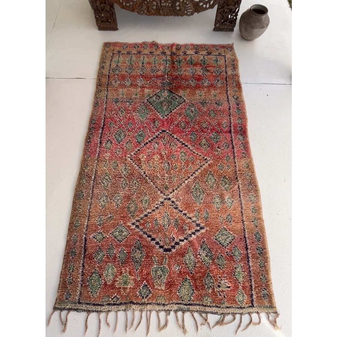 Vintage Moroccan Boujaad rug Weaver's Intuition with a raspberry red and magenta field, scattered with irregular pale turquoise diamonds and a navy line border.