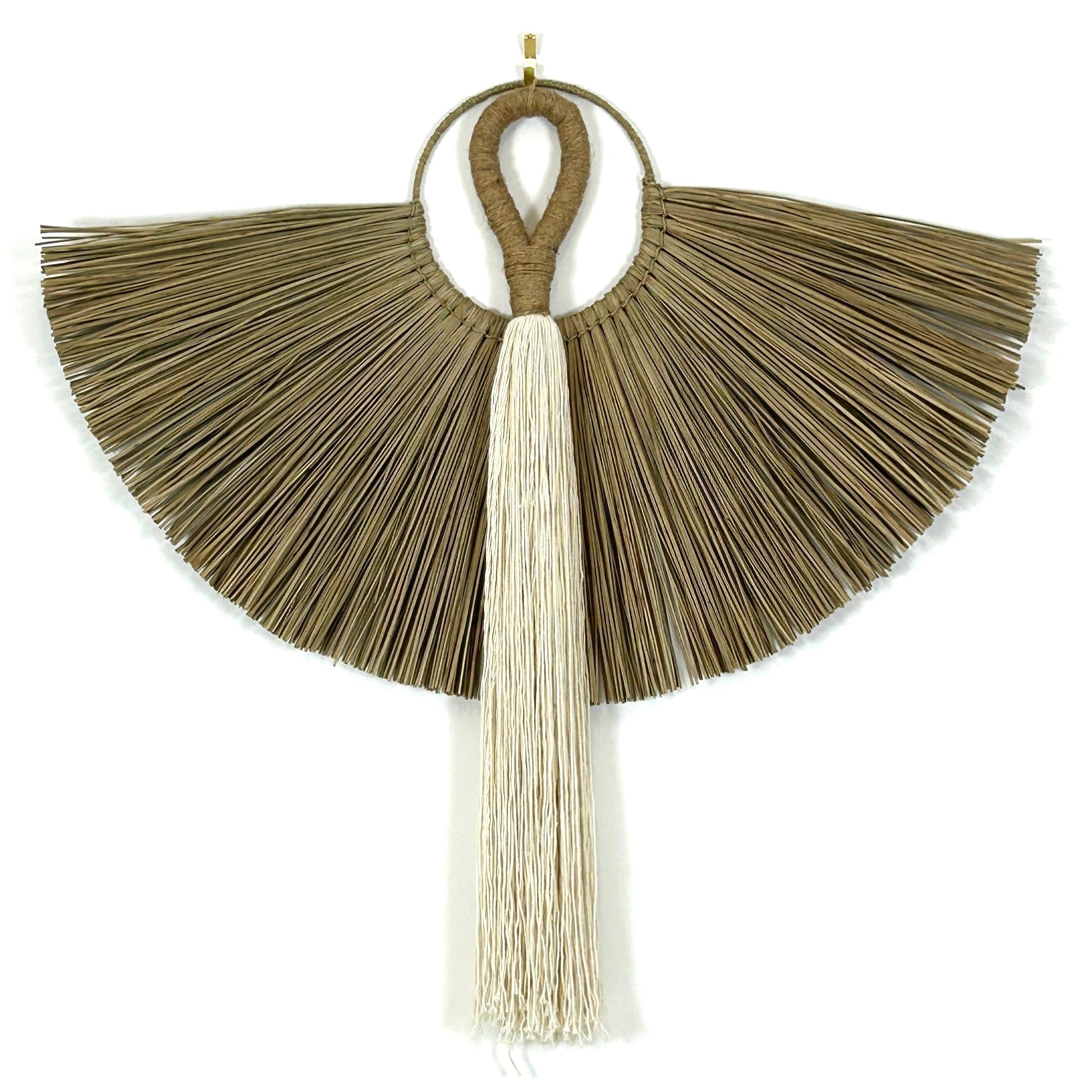 White cotton and jute handle tassel wall hanging, shown with a grass wall hanging against a white wall.