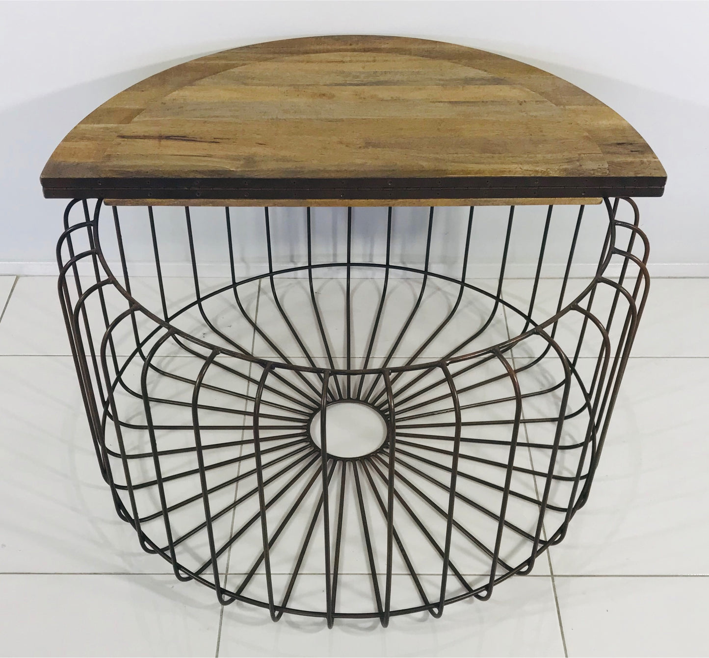 Top down full view of wooden coffee table with table top open to a metal frame beneath.