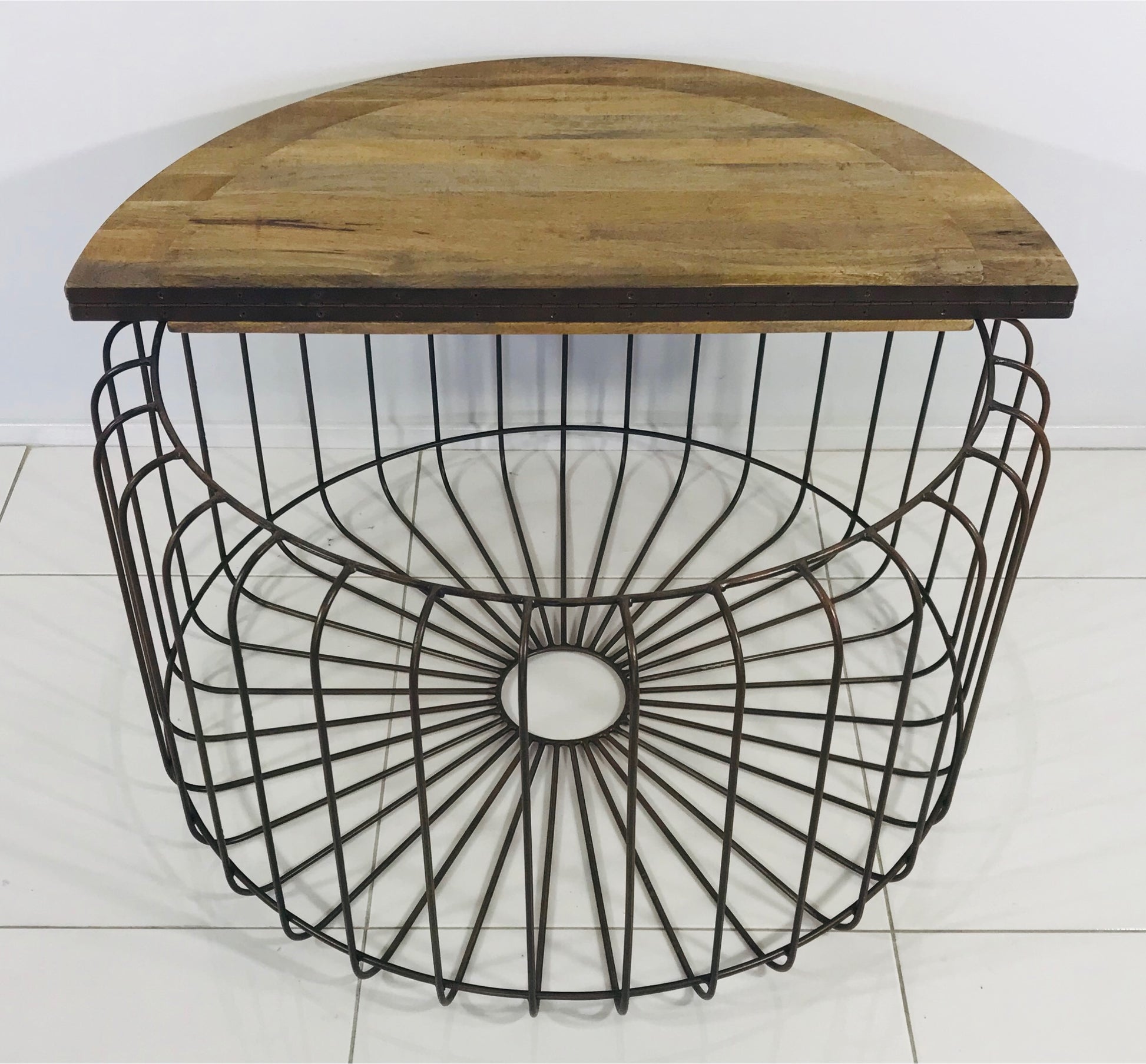 Top down full view of wooden coffee table with table top open to a metal frame beneath.