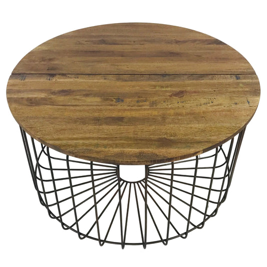 A round coffee table with a natural timber tabletop and a bronzed metal base, with a geometric pattern.