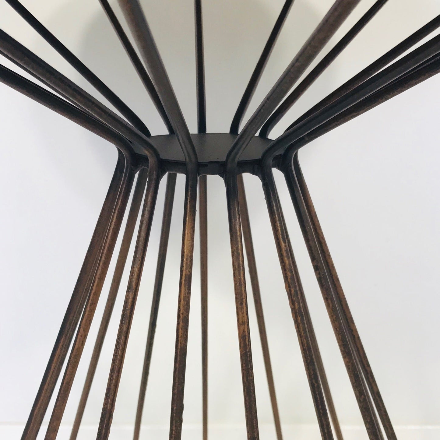 Close-up of a metal table frame with a white background