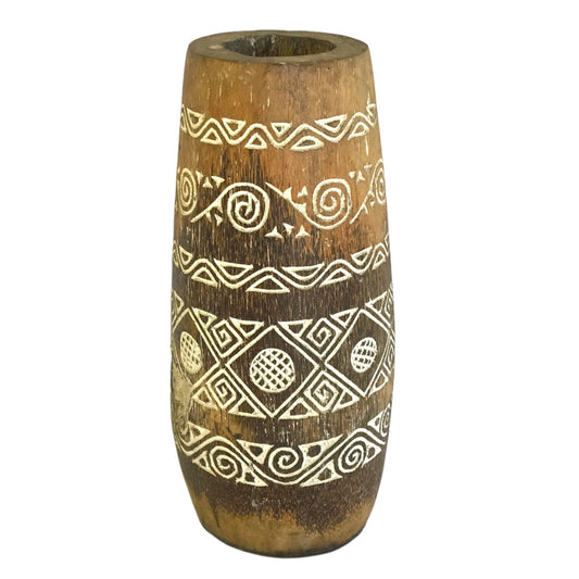 A tall dark coconut wood pot featuring intricate white-etched tribal patterns and a natural fibrous grain.