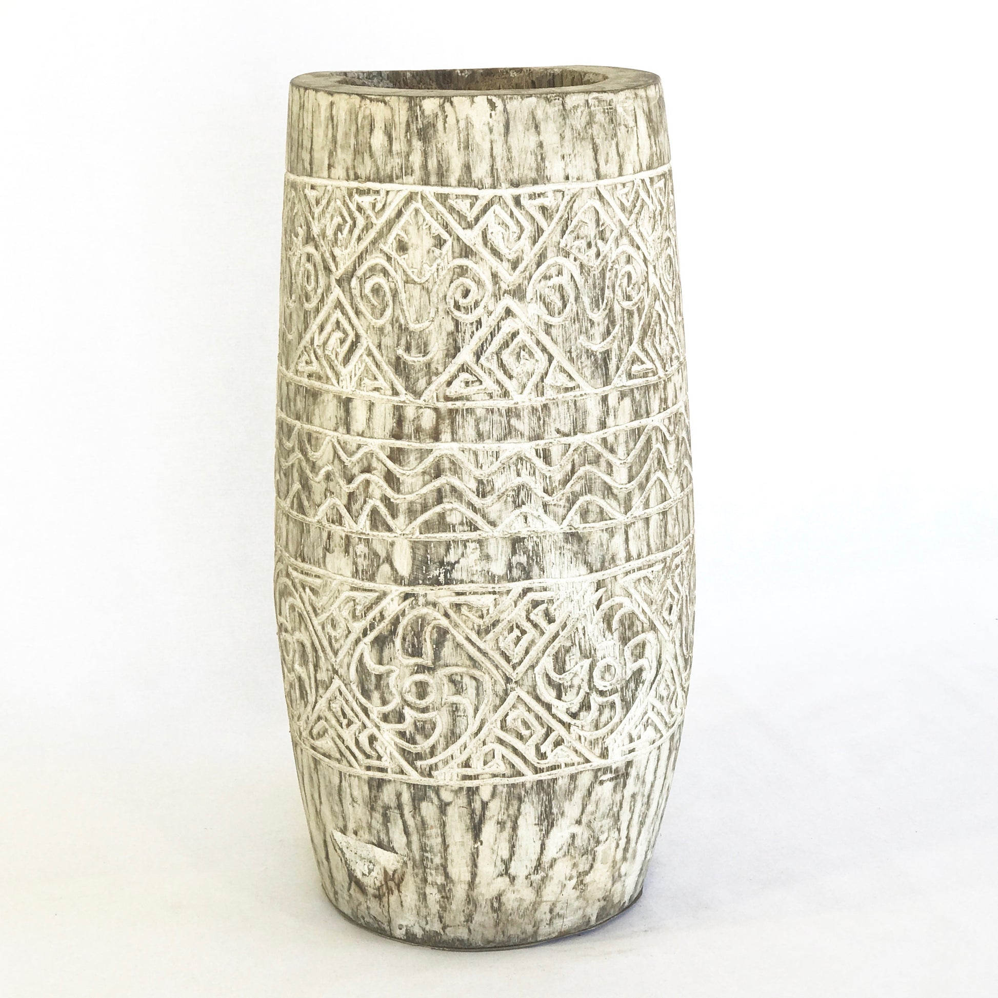 A tall white coconut wood vessel featuring intricate white-etched tribal patterns and a natural fibrous grain.