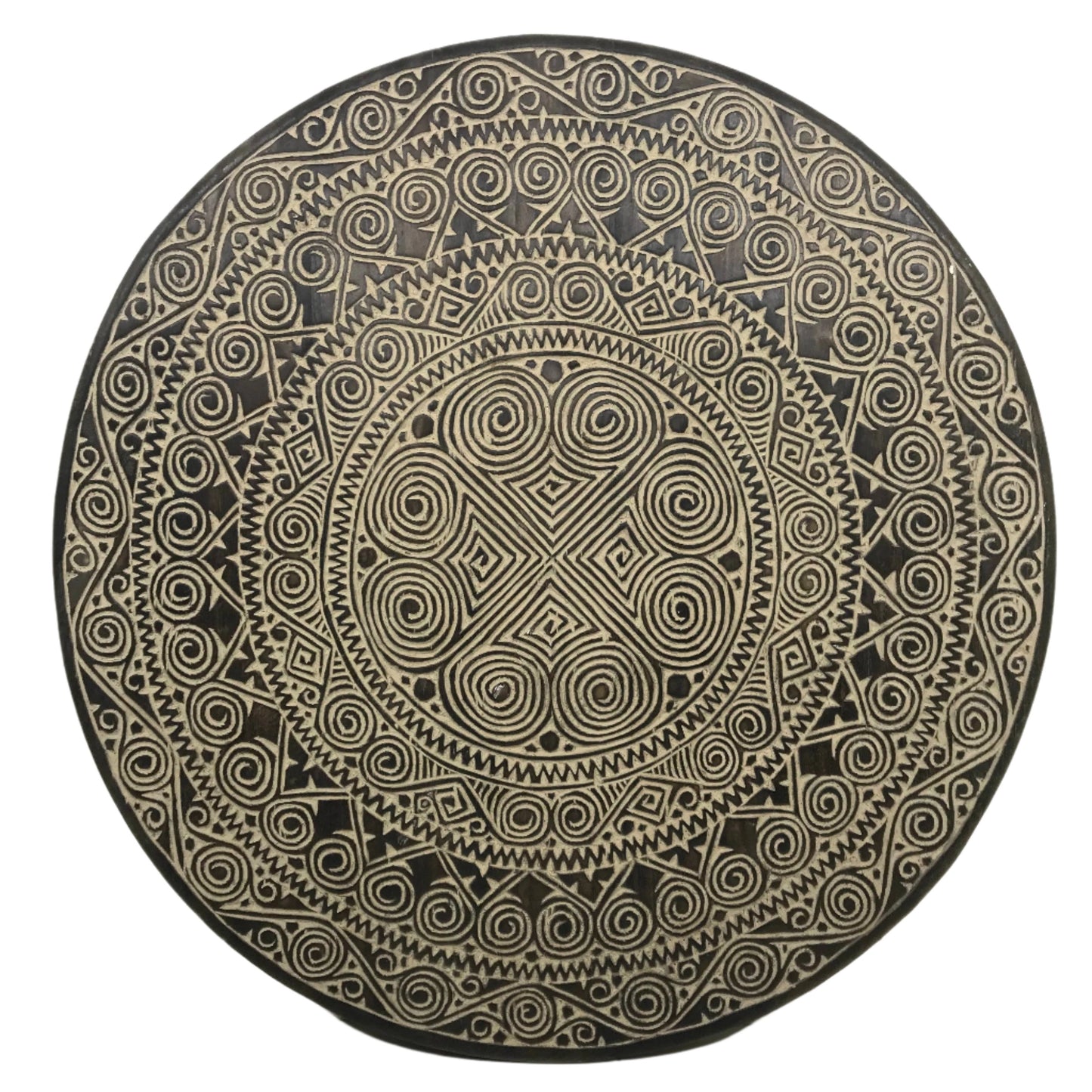 Circular 90cm hand-carved timber wall disc with ebony stained background, featuring Toraja-inspired concentric mandala of spiral pa'barre allo motifs, zigzag sunburst and diamond cross-hatch patterns, Bali.