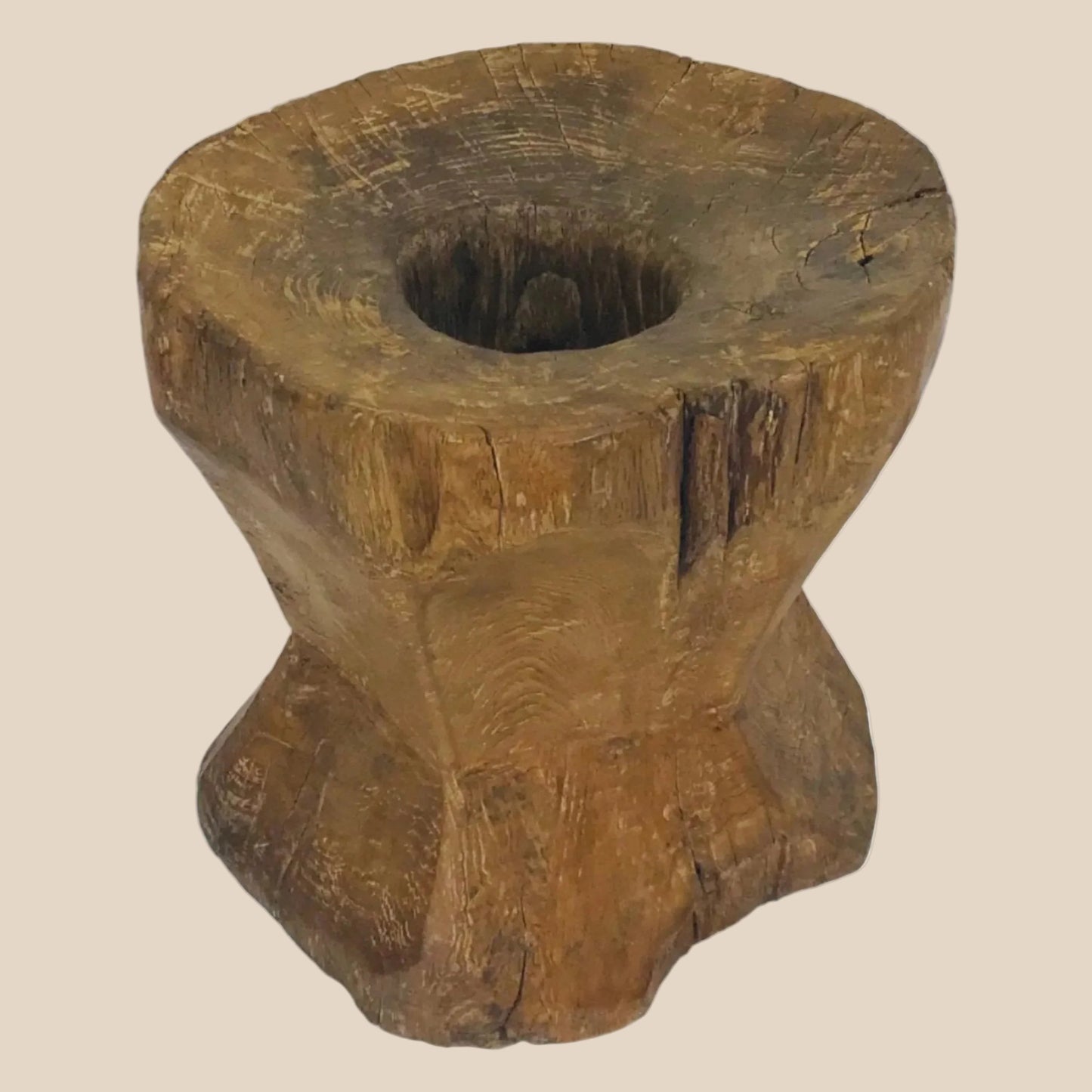 Hand-carved vintage Indonesian teak wood grinder with weathered texture and natural grain, side profile image.