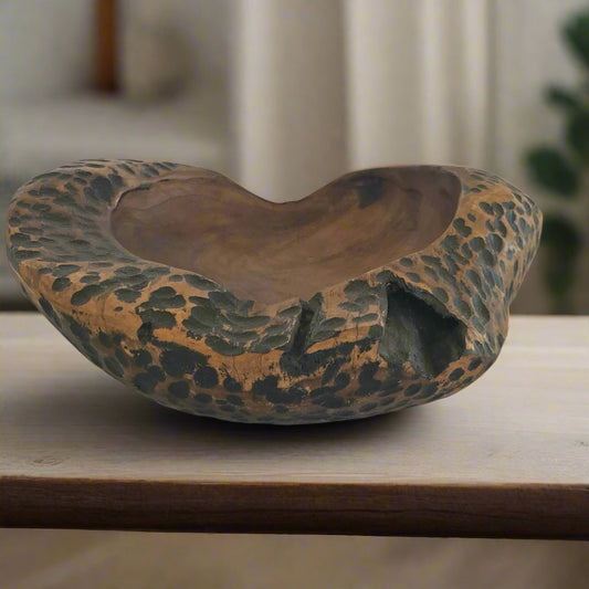 Wild wood teak bowl styled on a wooden tabletop.